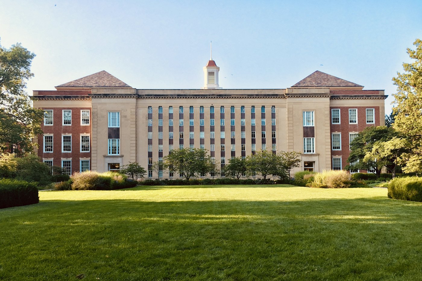 Founders Hall rising above the main campus lawn on a clear afternoon
